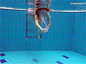 sandy-haired Simonna displaying her body underwater